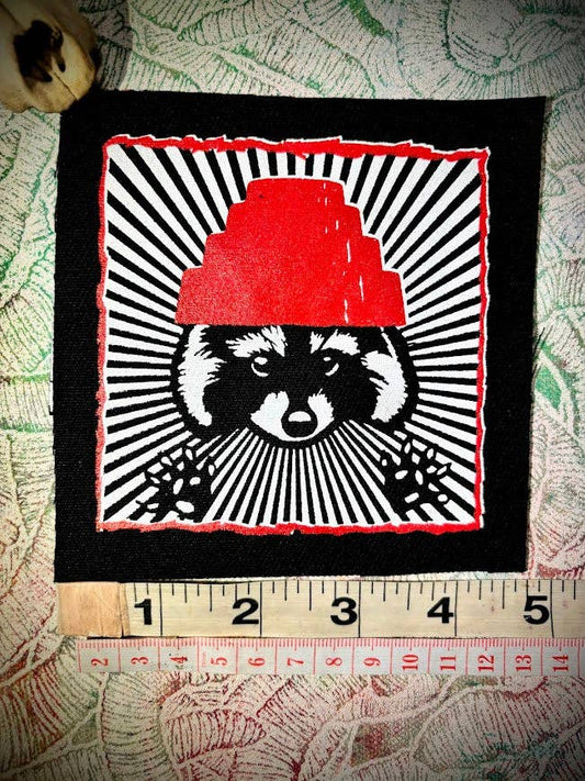 Are We not Trashy? Raccoon with a Devo hat patch.