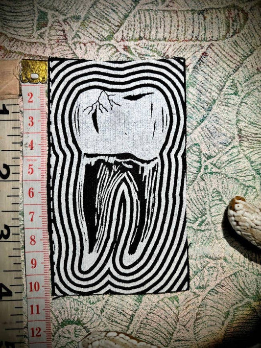 Tooth with a toothache patch.