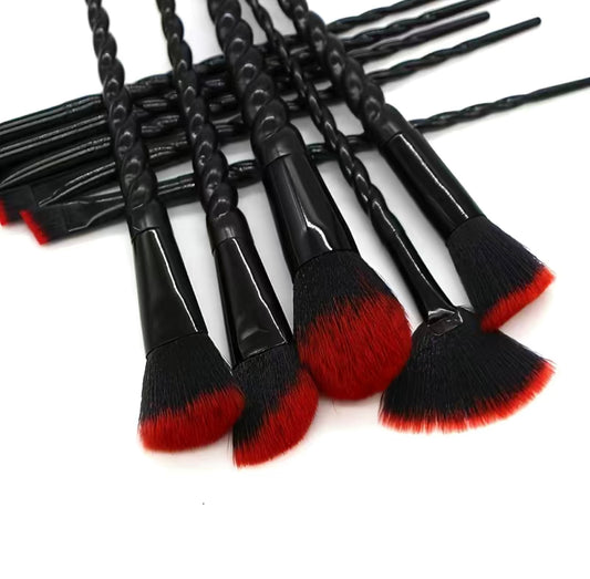 A collection of 10 makeup brushes with red and black wooden handles
