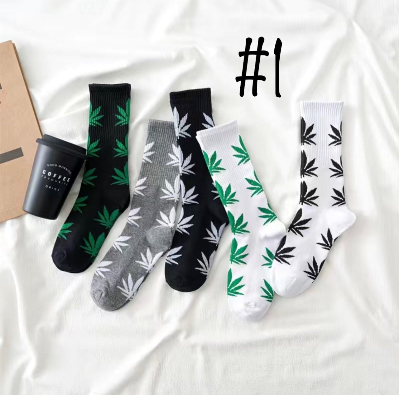 A set of six men's crew socks in sizes 6-10 with cannabis leaf patterns